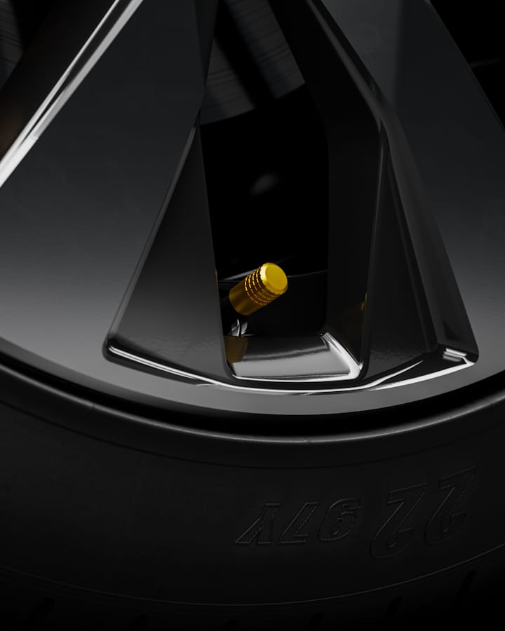 Zoom in on the wheel showing a yellow gold valve cap.