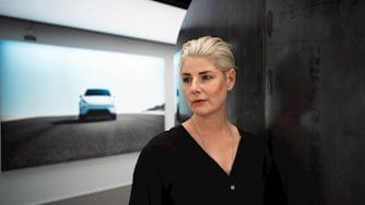 Linda Skogsberg standing in front of picture of Polestar 4